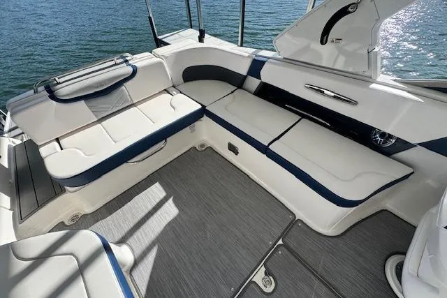 Slide: The Image of 2021 Chaparral 307 SSX boat interior with white and blue seating, overlooking water. - 27