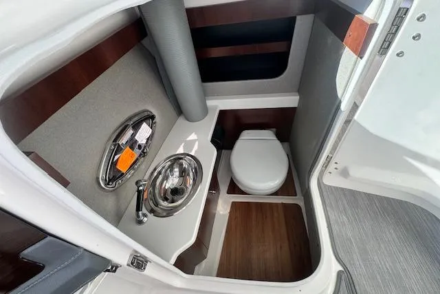 Slide: The Image of 2021 Chaparral 307 SSX boat bathroom with sink and toilet, modern design. - 28