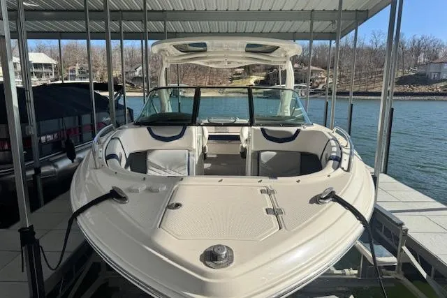 Slide: The Image of Chaparral 307 SSX 2021 boat docked under a covered marina on a sunny day. - 3