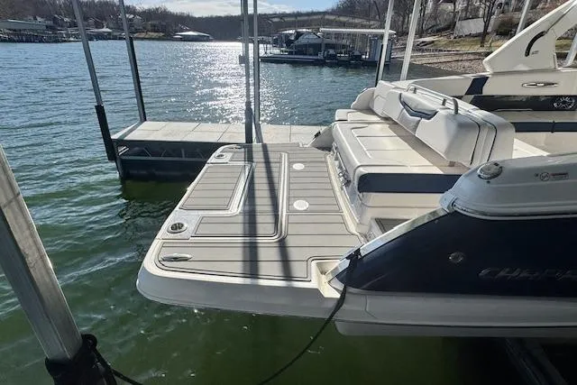 Slide: The Image of 2021 Chaparral 307 SSX boat docked on a sunny lake. - 30