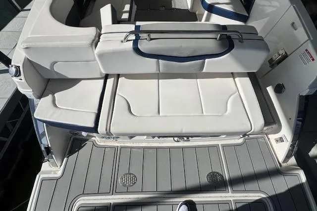 Slide: The Image of 2021 Chaparral 307 SSX boat interior with white seating and gray flooring. - 32