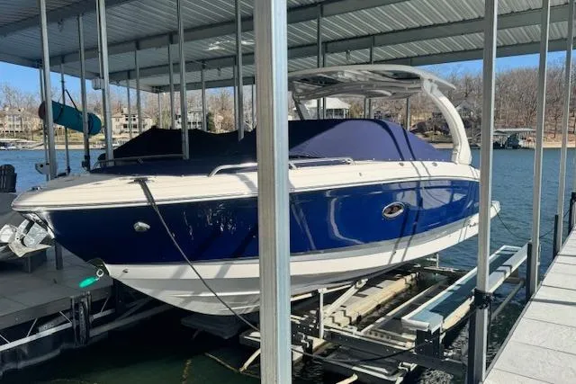 Slide: The Image of 2021 Chaparral 307 SSX boat docked under a covered marina. - 34