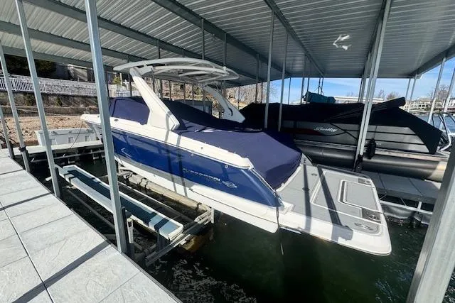 Slide: The Image of 2021 Chaparral 307 SSX boat docked under a covered marina. - 37