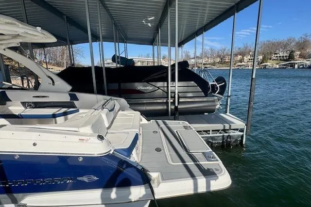 Slide: The Image of 2021 Chaparral 307 SSX docked at a marina with scenic lake view. - 38