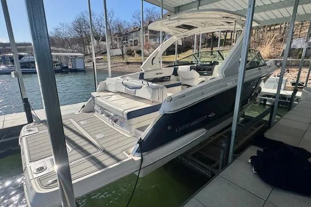 Slide: The Image of 2021 Chaparral 307 SSX boat docked in a marina, showcasing sleek design and spacious seating. - 4
