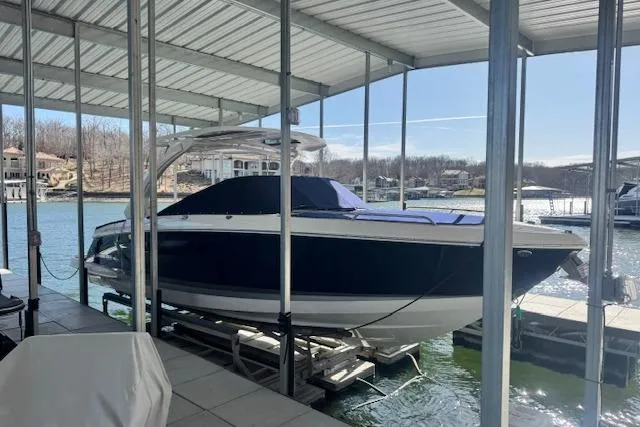 Slide: The Image of 2021 Chaparral 307 SSX boat docked under a covered marina. - 5