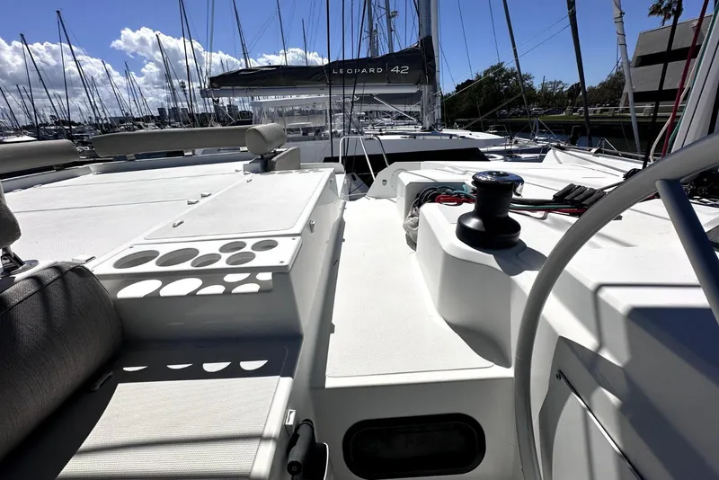 Slide: The Image of 2023 Bali CATSPACE catamaran deck with winch, docked in a marina under a sunny sky. - 10