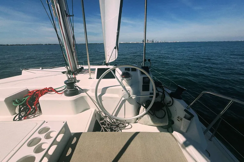 Slide: The Image of 2023 Bali CATSPACE sailboat cockpit with steering wheel, ropes, and ocean view. - 12