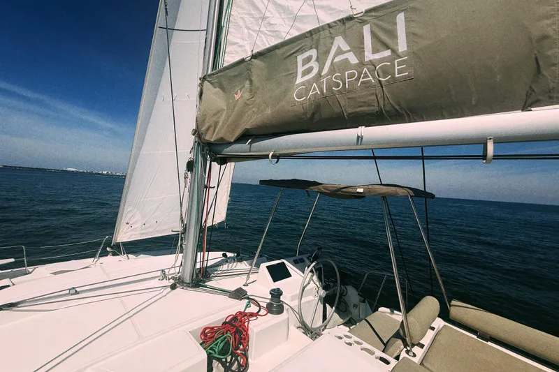 Slide: The Image of 2023 Bali CATSPACE catamaran sailing on open sea under clear blue sky. - 13