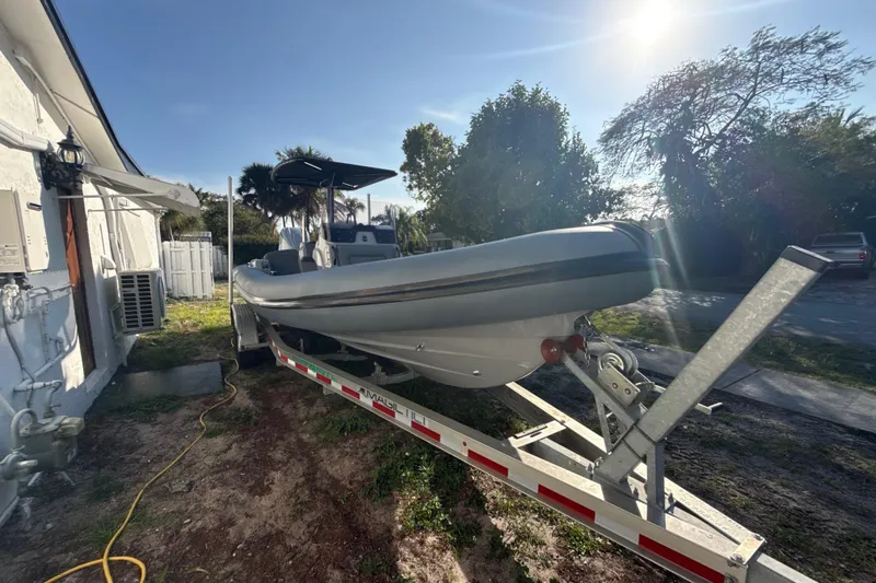 The Image of 2022 Ribeye HFM boat on trailer in a warehouse setting. - 0