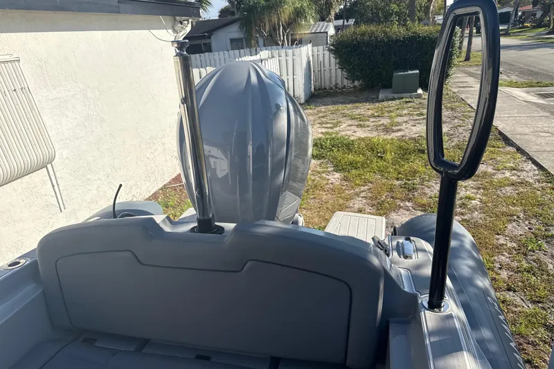 Slide: The Image of Ribeye HFM 2022 boat with outboard motor and ladder, parked near a building. - 10