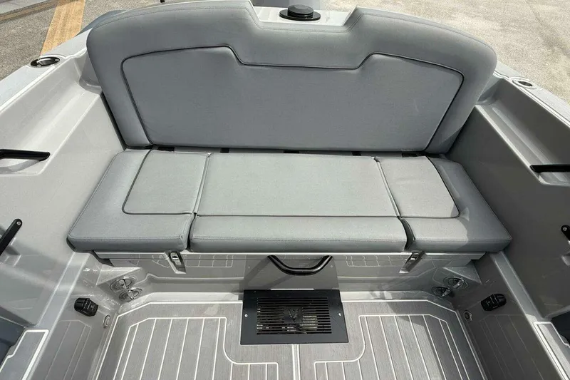 Slide: The Image of Ribeye HFM 2022 boat with outboard motor, parked outdoors near a white fence. - 14