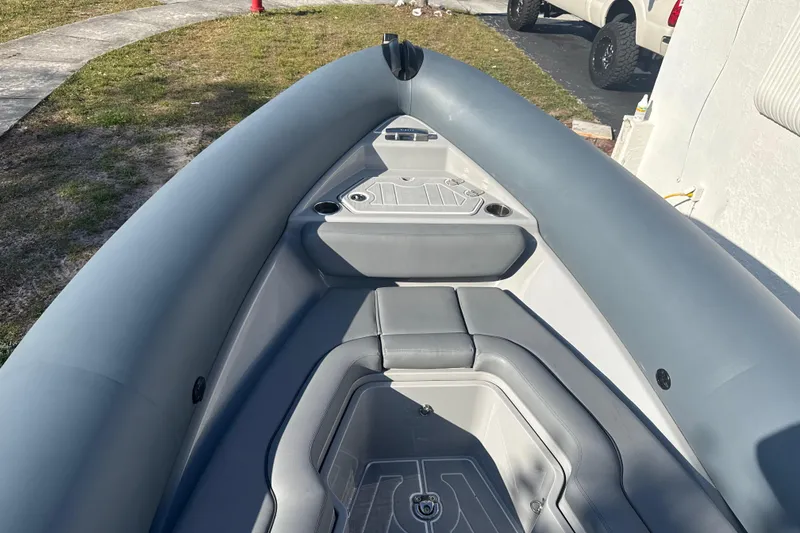 Slide: The Image of 2022 Ribeye HFM boat interior with gray seating and storage compartments. - 20