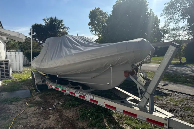 Slide: The Image of Covered 2022 Ribeye HFM boat on trailer, parked outdoors in a sunny yard. - 21