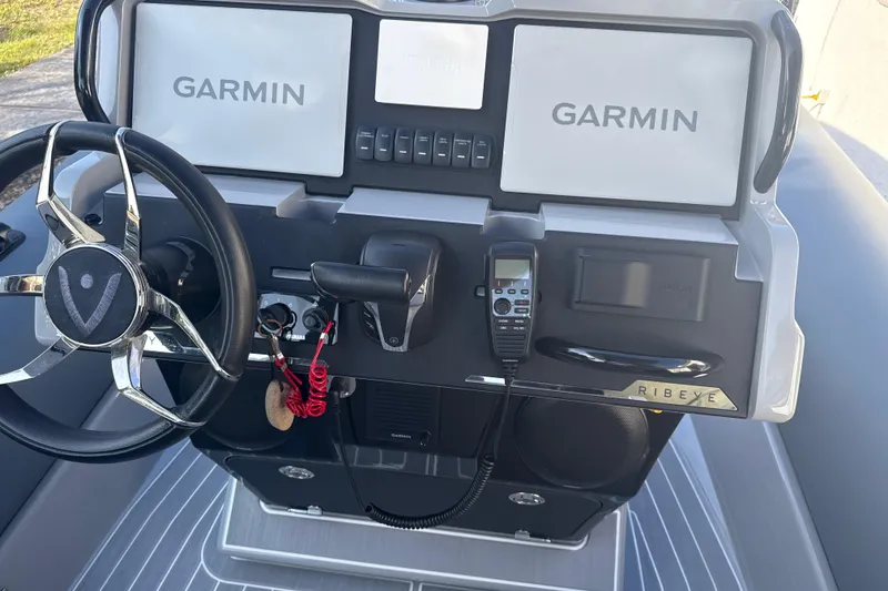 Slide: The Image of 2022 Ribeye HFM boat with sleek design, parked outdoors under sunlight. - 8