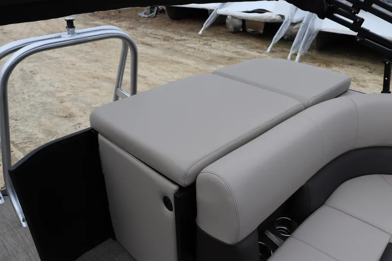 Slide: The Image of 2026 Bentley Pontoons Legacy 223 Cruise interior seating with beige upholstery and cup holders. - 9