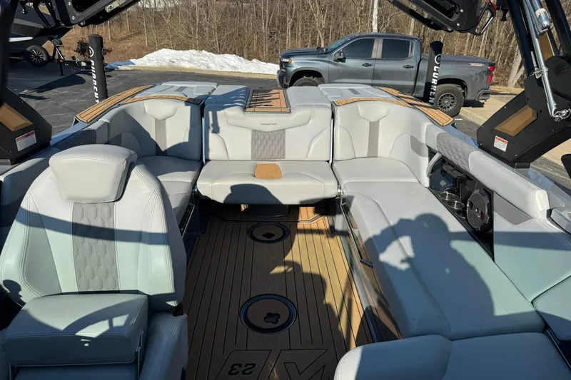 Slide: The Image of 2023 MasterCraft XT23 boat interior with luxurious seating and modern design. - 10