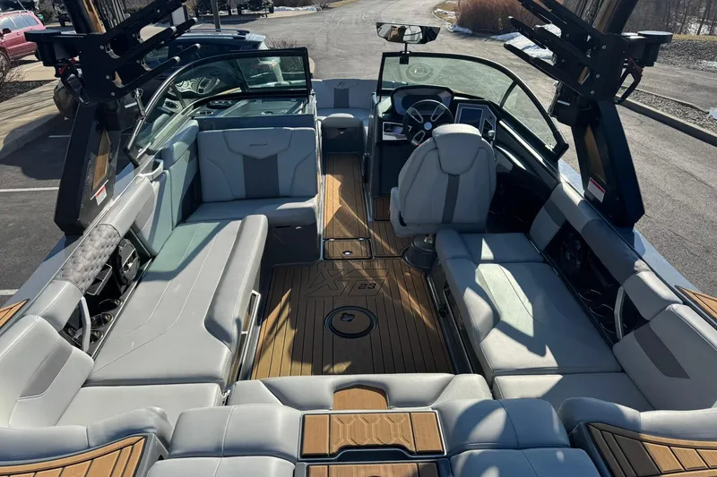 Slide: The Image of 2023 MasterCraft XT23 boat interior with luxurious seating and modern dashboard. - 11
