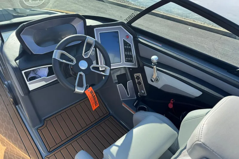 Slide: The Image of 2023 MasterCraft XT23 boat cockpit with modern steering wheel and control panel. - 8
