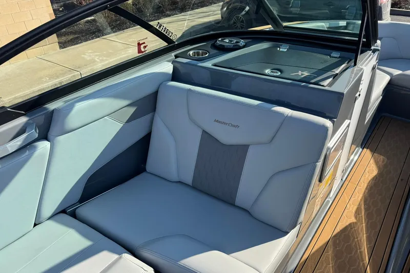 Slide: The Image of 2023 MasterCraft XT23 boat interior with luxurious seating and modern design. - 9