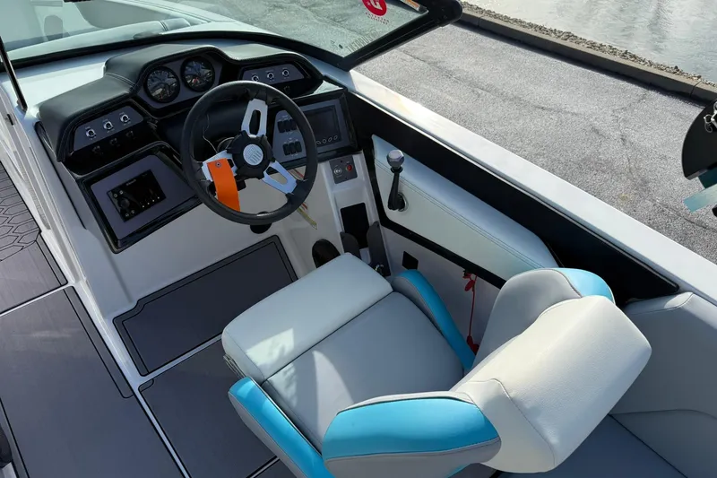 Slide: The Image of 2023 MasterCraft NXT23 boat cockpit with steering wheel and control panel. - 7