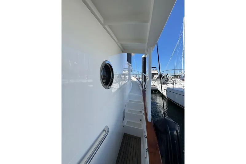Slide: The Image of 2008 Kadey-Krogen 44 Walk Around yacht, side deck view with porthole and railing. - 23