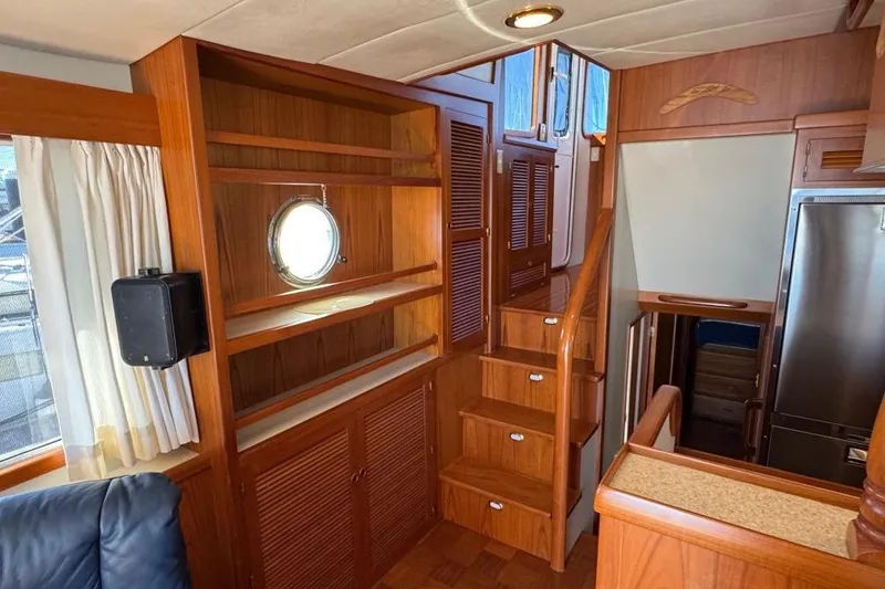 Slide: The Image of Interior of 2008 Kadey-Krogen 44 Walk Around yacht with wooden stairs and shelving. - 30