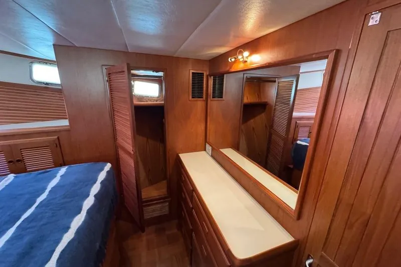 Slide: The Image of 2008 Kadey-Krogen 44 Walk Around yacht interior with wooden cabinetry and mirror. - 39