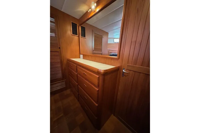 Slide: The Image of 2008 Kadey-Krogen 44 Walk Around interior with wooden cabinetry and mirror. - 40