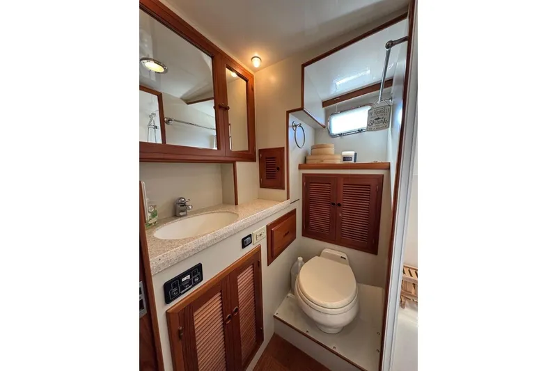 Slide: The Image of 2008 Kadey-Krogen 44 Walk Around yacht bathroom with wooden cabinets and modern fixtures. - 41