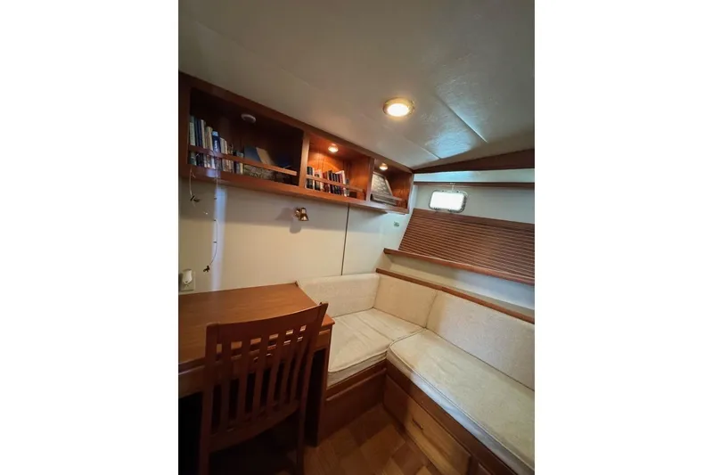 Slide: The Image of Cozy interior of 2008 Kadey-Krogen 44 Walk Around with wooden furniture and bookshelves. - 44