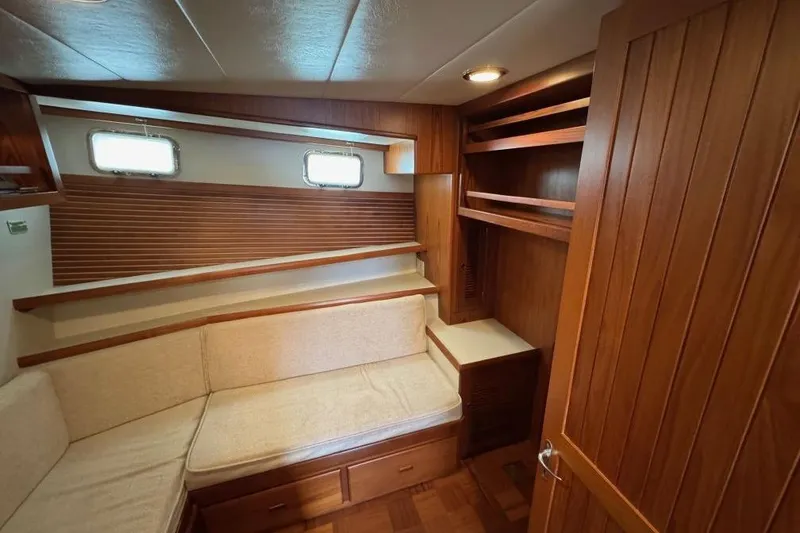 Slide: The Image of 2008 Kadey-Krogen 44 Walk Around interior with wood paneling and cozy seating area. - 45