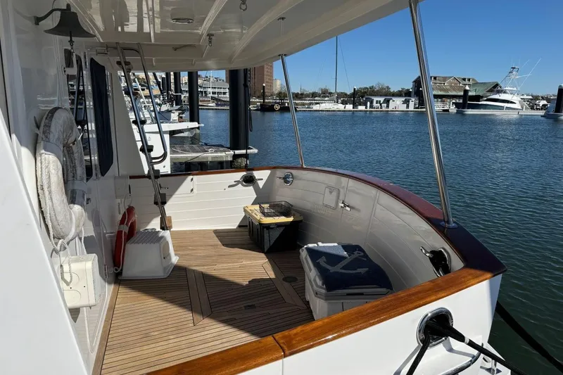 Slide: The Image of 2008 Kadey-Krogen 44 Walk Around yacht docked at marina, featuring spacious deck and scenic view. - 5