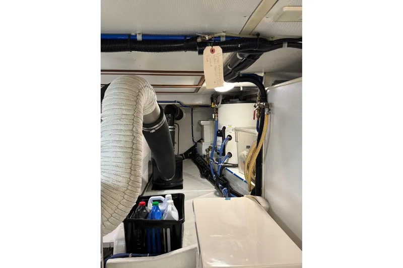 Slide: The Image of Engine room of 2008 Kadey-Krogen 44 Walk Around with hoses and maintenance supplies. - 55