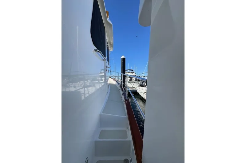 Slide: The Image of 2008 Kadey-Krogen 44 Walk Around yacht docked, showcasing side deck and railing. - 6