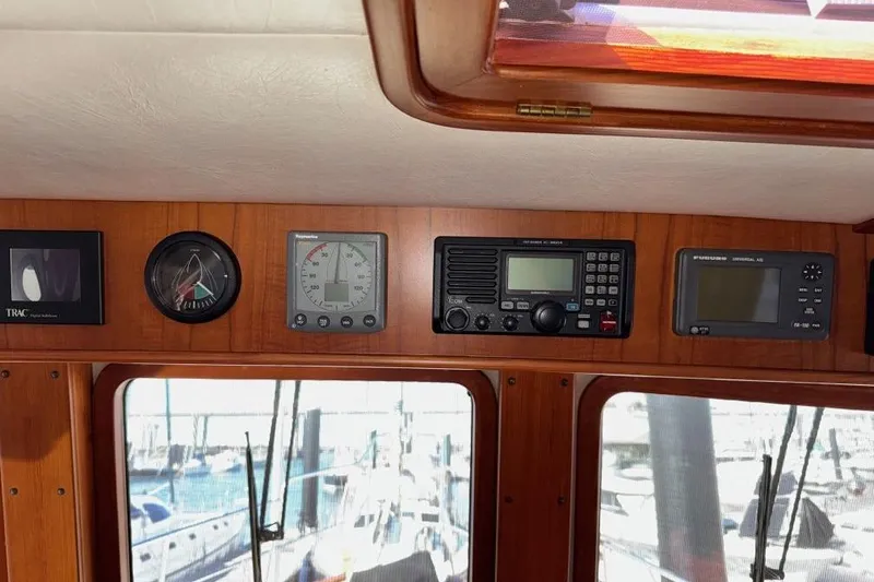 Slide: The Image of 2008 Kadey-Krogen 44 Walk Around yacht dashboard with navigation instruments and controls. - 71