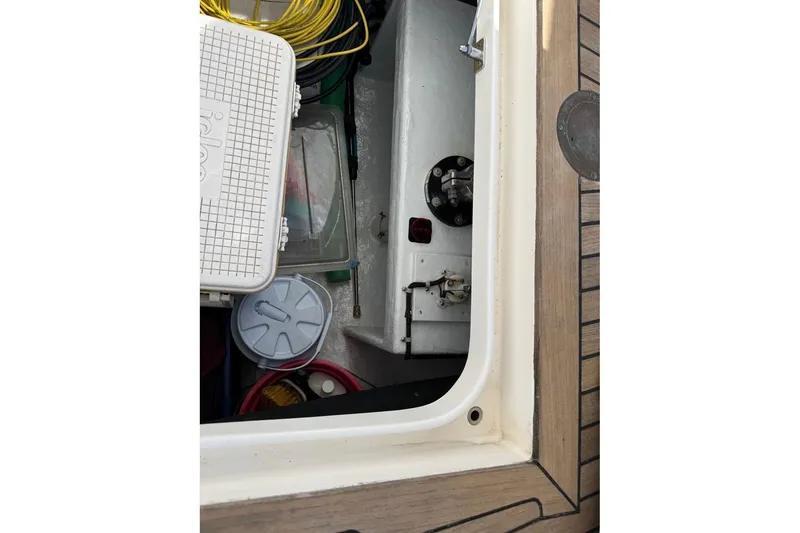 Slide: The Image of Storage compartment on 2008 Kadey-Krogen 44 Walk Around boat with various equipment. - 74
