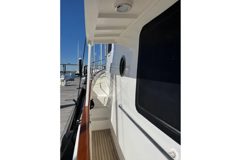 Slide: The Image of 2008 Kadey-Krogen 44 Walk Around yacht, side deck view with railing and window. - 77