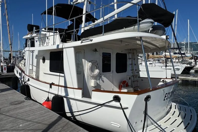 Slide: The Image of 2008 Kadey-Krogen 44 Walk Around yacht docked at marina, featuring classic design and white exterior. - 80