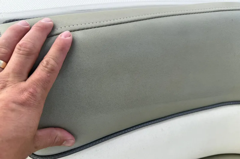 Slide: The Image of Hand touching upholstery on 2005 Sea Ray 220 Sundeck boat seat. - 12