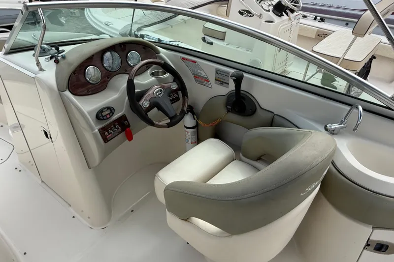 Slide: The Image of 2005 Sea Ray 220 Sundeck helm with steering wheel and control panel. - 18