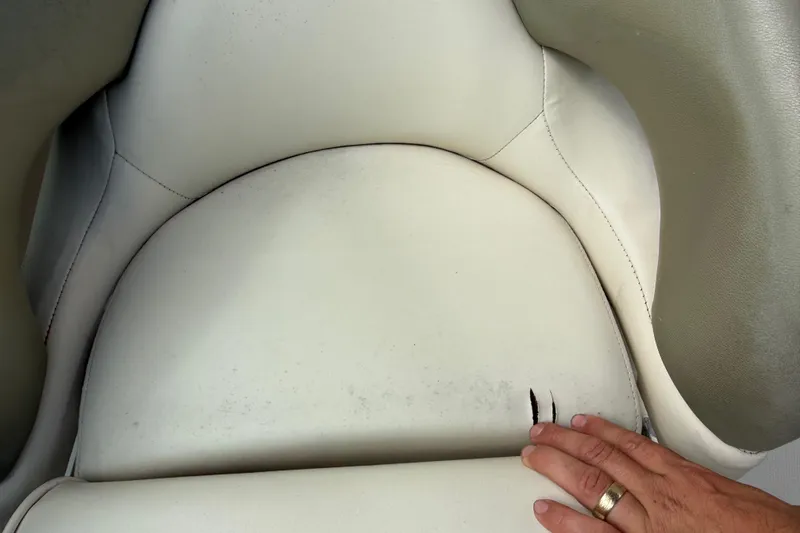 Slide: The Image of Close-up of worn seat upholstery on a 2005 Sea Ray 220 Sundeck boat. - 19