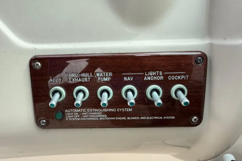 Slide: The Image of Control panel of a 2005 Sea Ray 220 Sundeck boat with labeled switches. - 23