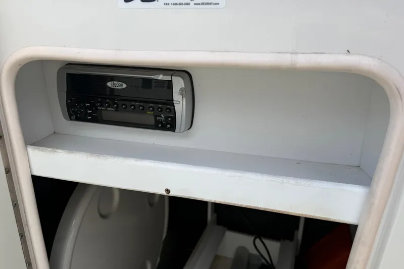 Slide: The Image of 2005 Sea Ray 220 Sundeck interior with Clarion stereo system. - 26
