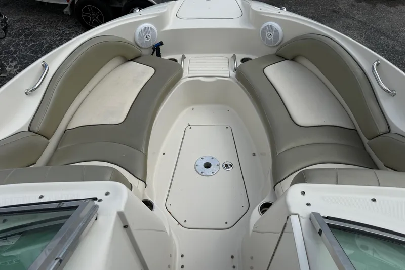 Slide: The Image of 2005 Sea Ray 220 Sundeck interior with beige seating and speaker system. - 27
