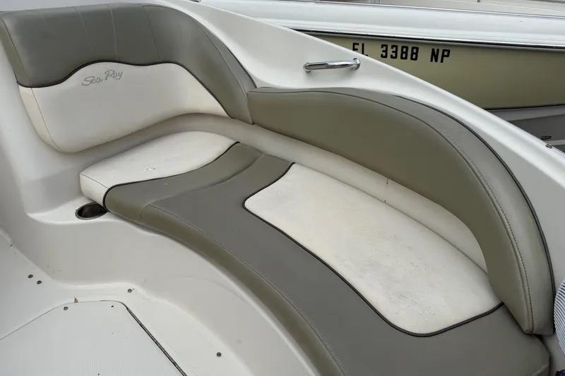 Slide: The Image of 2005 Sea Ray 220 Sundeck boat interior seating with gray and white upholstery. - 28