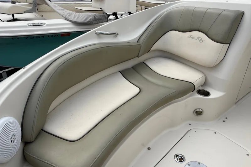 Slide: The Image of 2005 Sea Ray 220 Sundeck boat interior with cushioned seating and speaker. - 29