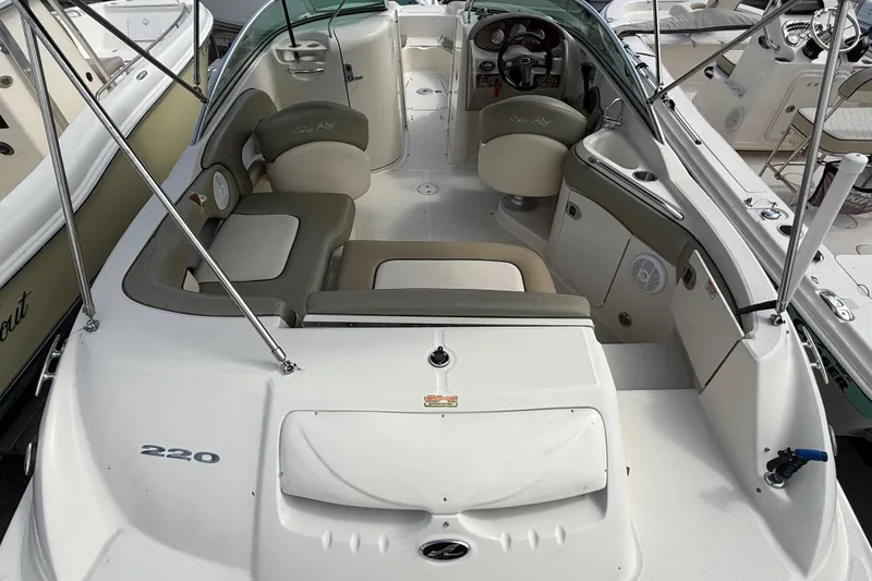 Slide: The Image of 2005 Sea Ray 220 Sundeck interior with seating and steering console. - 8