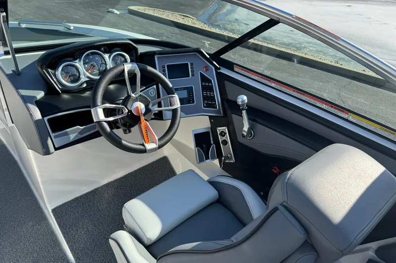 Slide: The Image of 2019 MasterCraft XT23 boat interior with steering wheel and dashboard controls. - 10