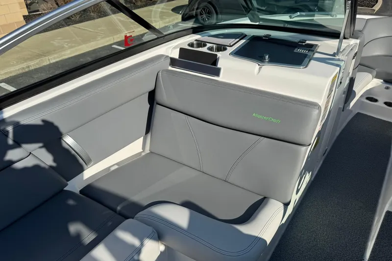 Slide: The Image of 2019 MasterCraft XT23 boat interior with gray seating and cup holders. - 11